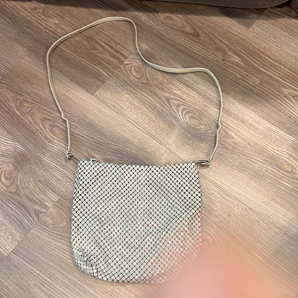 Whiting and Davis gray metal and leather crossbody bag with adjustable straps.